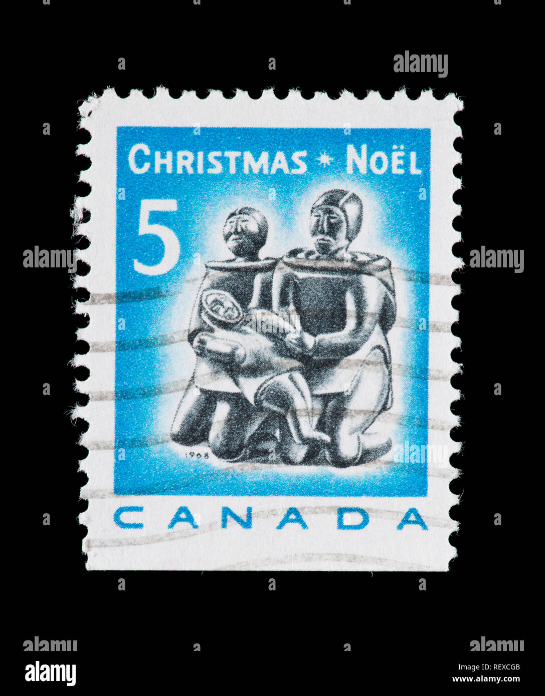 Postage stamp from Canada depicting an Eskimo soapstone carving of a family Stock Photo