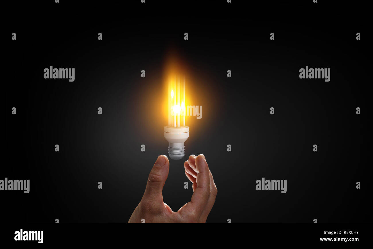 Business hand holding glowing light bulb against Stock Photo - Alamy
