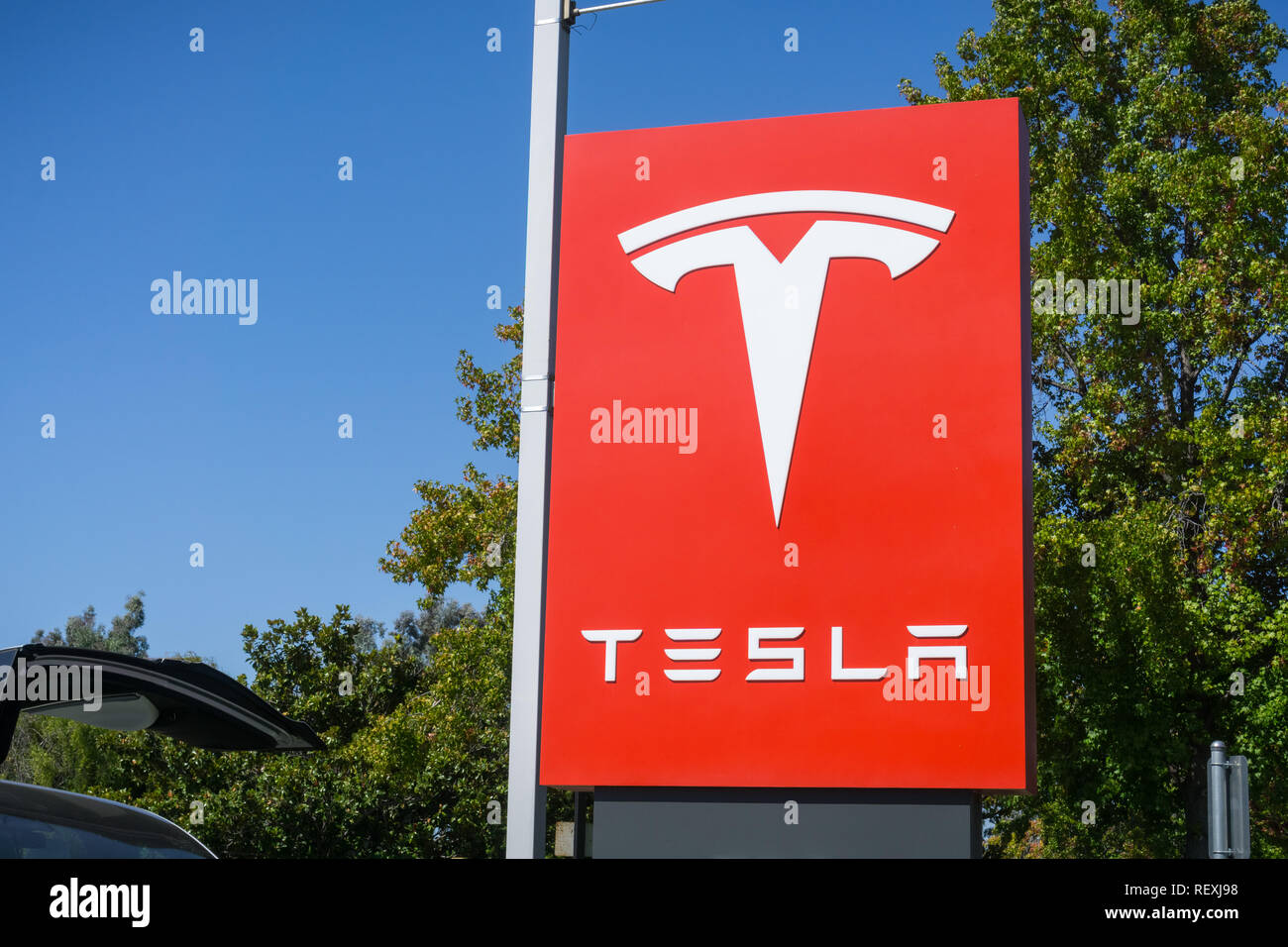 October 3, 2017 Sunnyvale/CA/USA - Tesla logo in front of a showroom located in San Francisco bay area Stock Photo