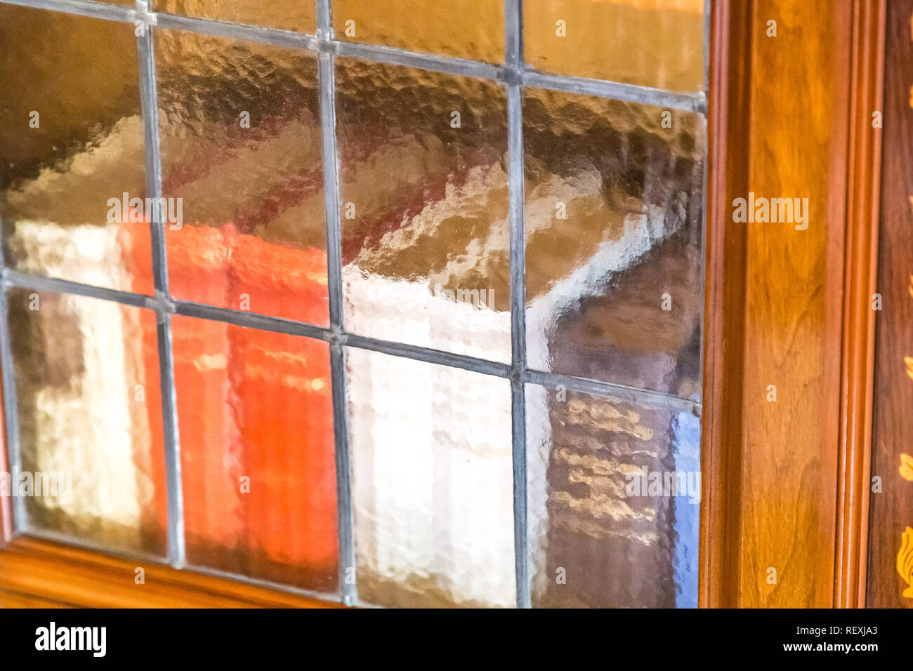 Books in antique wooden bookcase with frosted glass doors Stock Photo Alamy