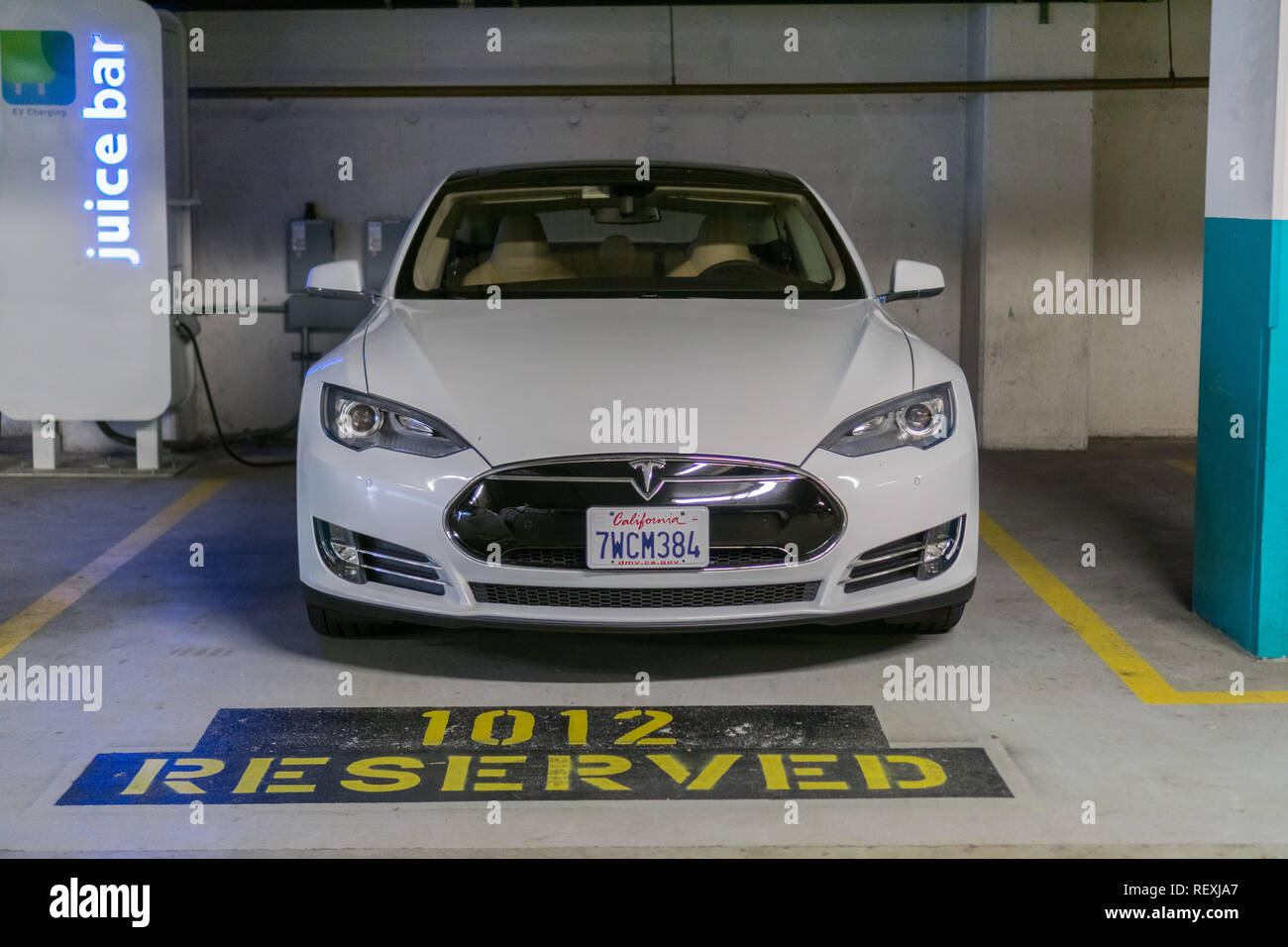 October 7, 2017 San Francisco/CA/USA - Tesla Model S car recharging in a reserved underground parking lot Stock Photo