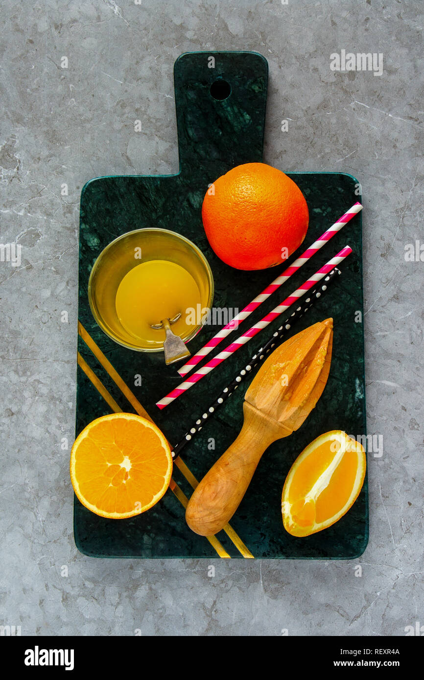 Making orange juice. Flat lay of organic fruits for making squized juice. Healthy lifestyle and summer beverages Stock Photo
