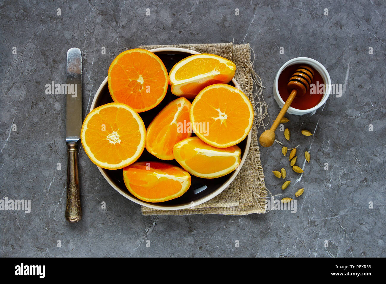 Making natural hot drink. Ripe oranges, honey and spices flat-lay. Healthy beverages Stock Photo