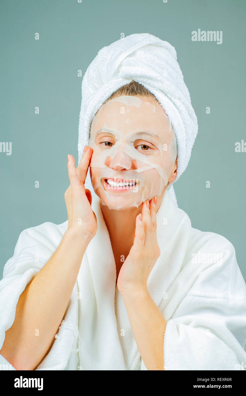Facial care and beauty treatments. Beautiful woman with a sheet