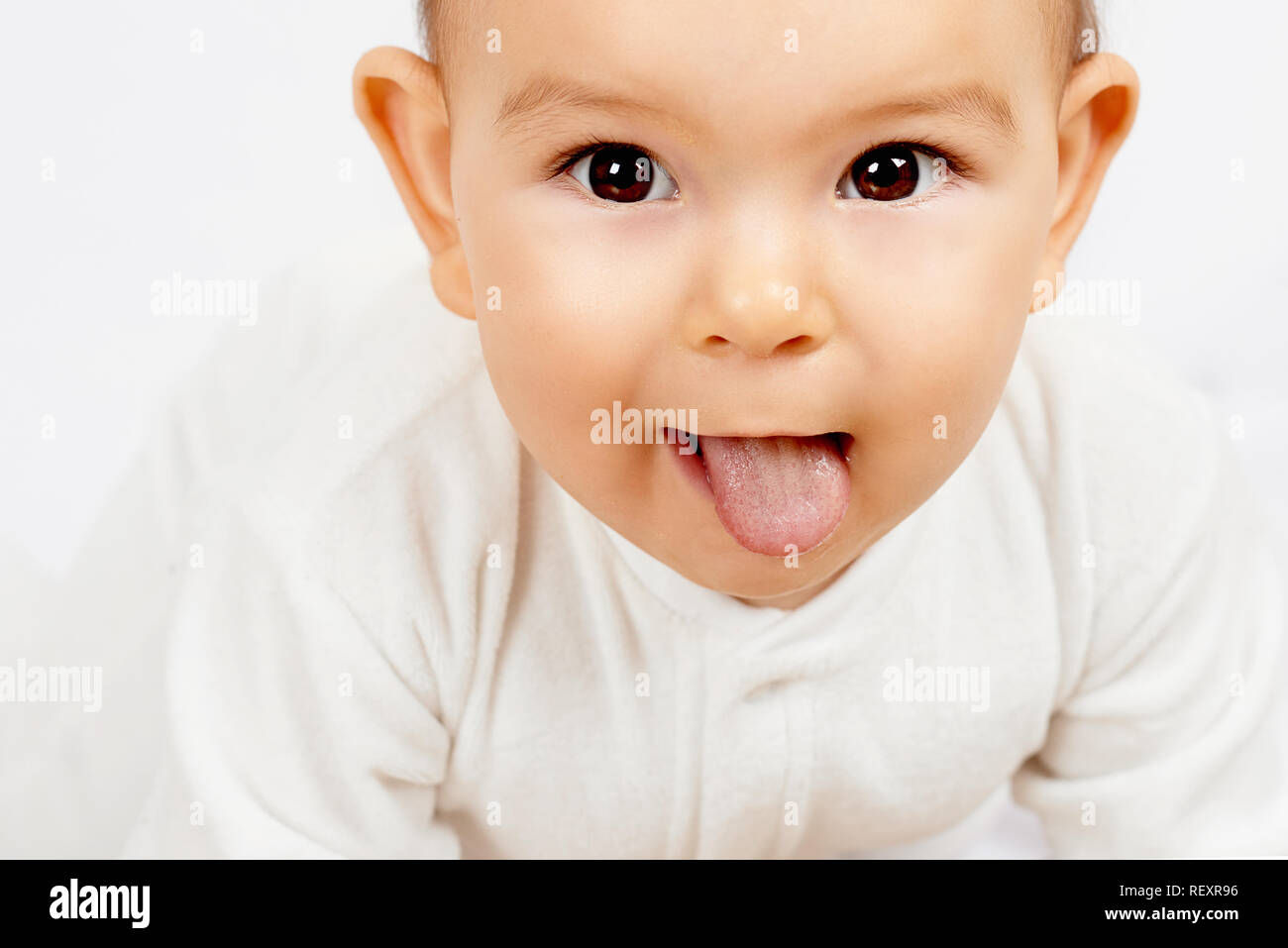 White coating on tongue baby. Oral thrush. funny toddler expression Stock Photo