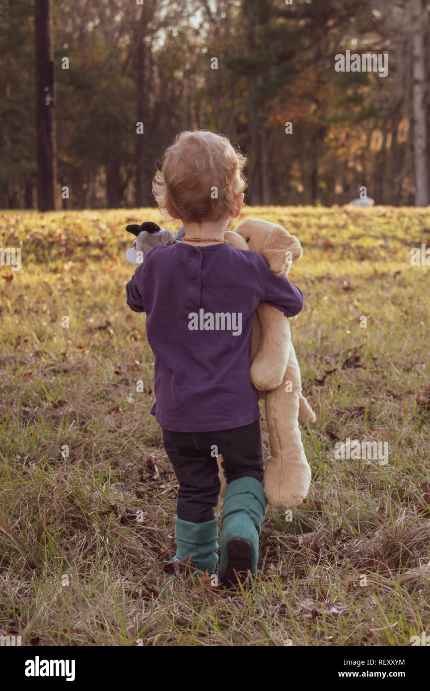 Little Girl with stuffed animal walking away Stock Photo - Alamy