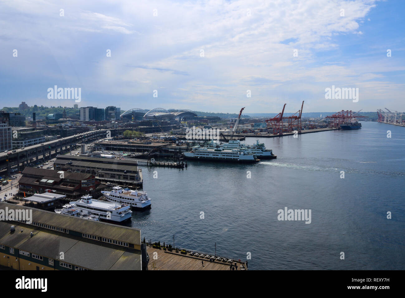 Seattle Puget Sound harbor marine landscape aerial view on a sunny partly cloudy day with cruise ships docked and rows of ports in the background, sta Stock Photo
