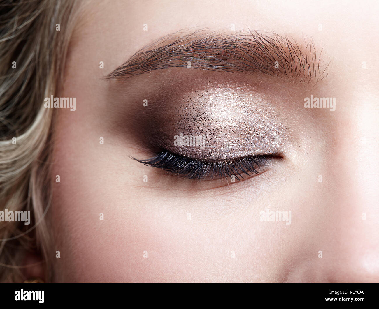Closeup macro shot of closed human woman eye. Female with smoky eyes makeup Stock Photo
