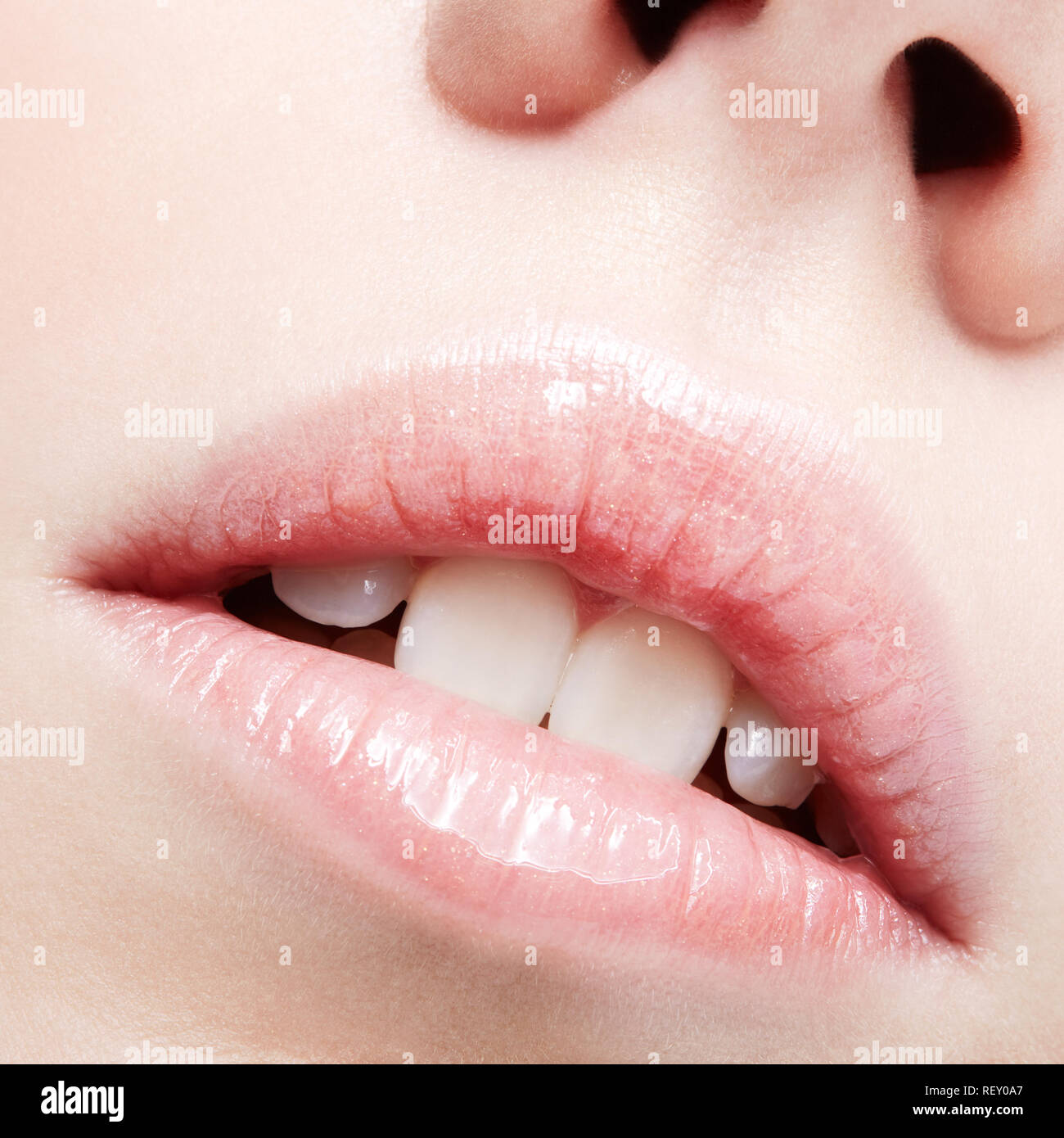 Closeup shot of human female face. Woman with pink plump lips makeup. Stock Photo