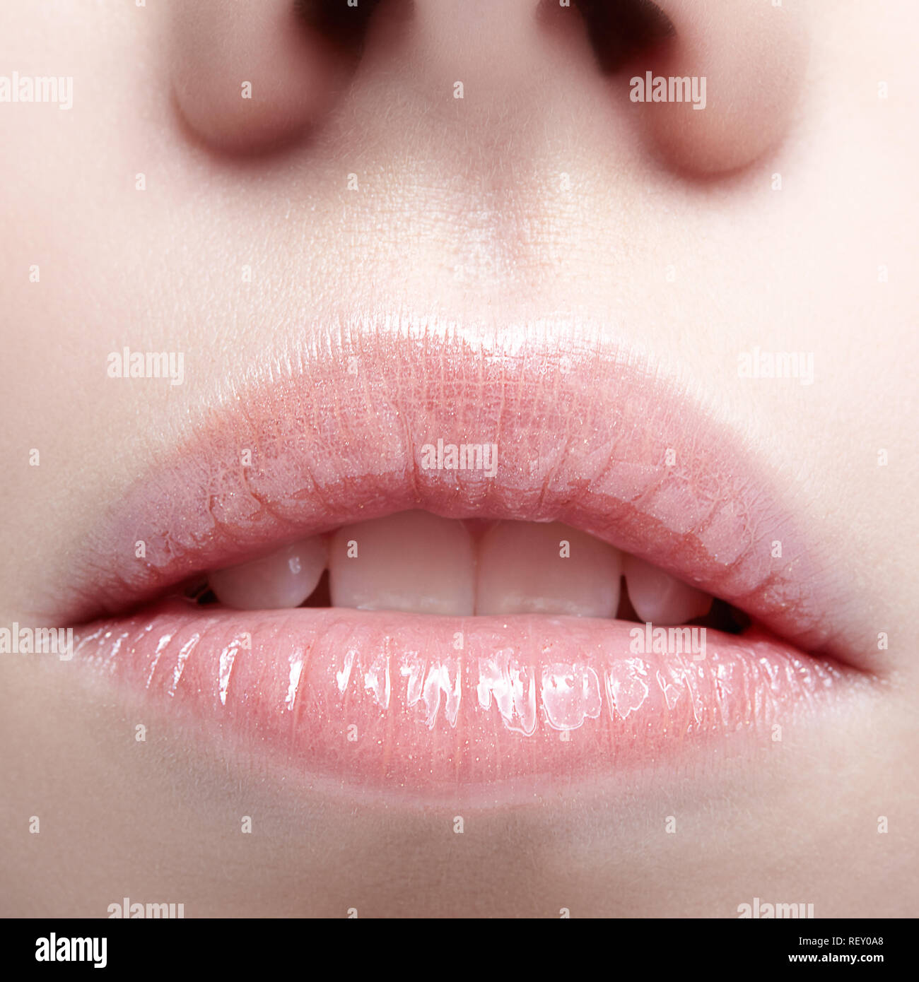 Closeup shot of human female face. Woman with pink plump lips makeup. Stock Photo
