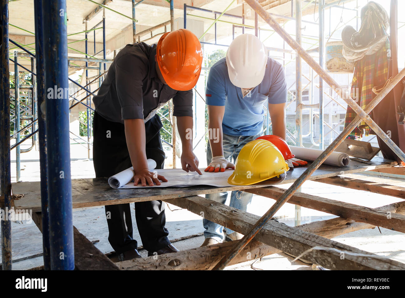 Engineer discussing with foreman about project in building construction site Stock Photo