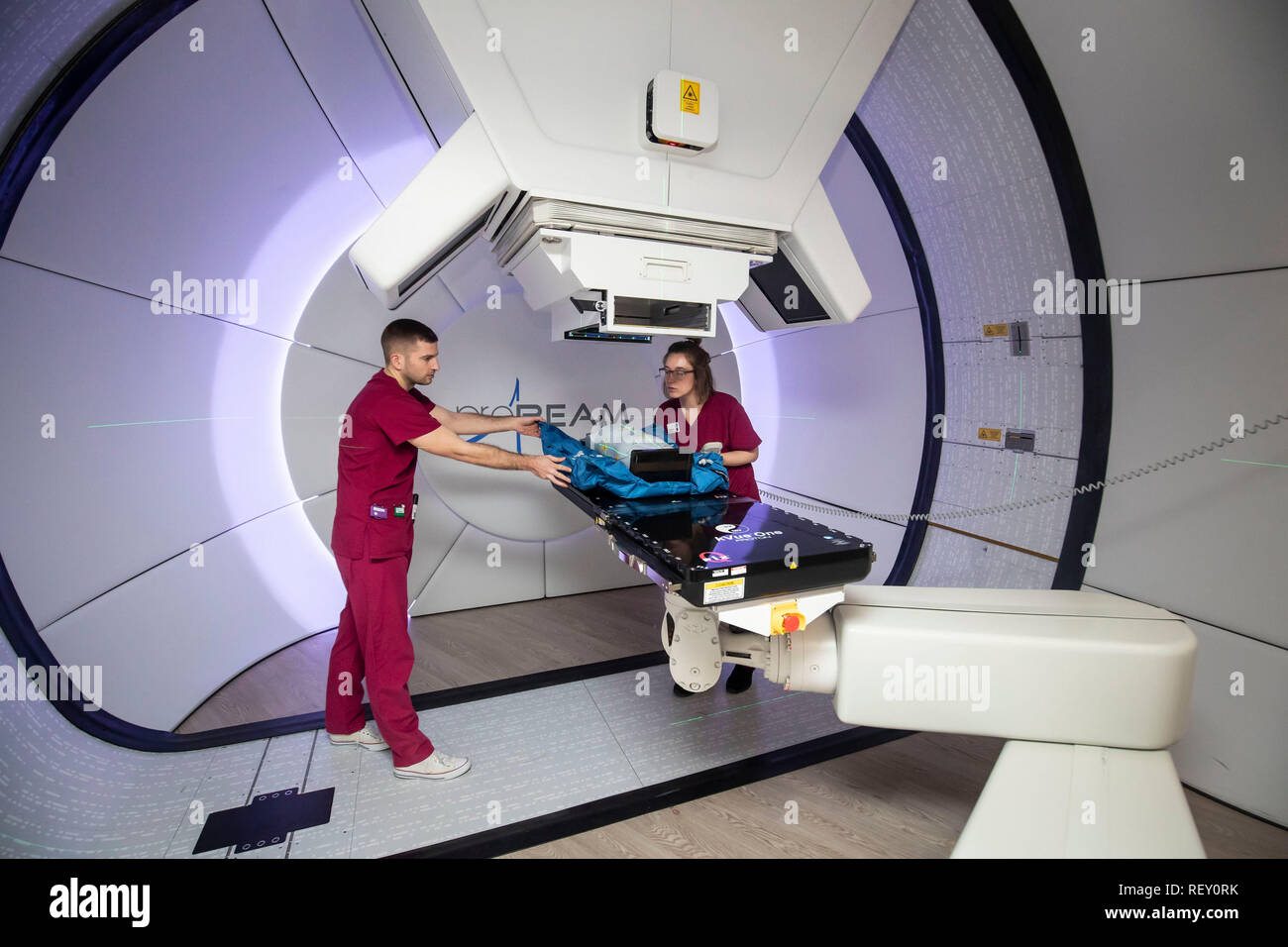 Radiographers David Kirk (left) and Melissa Bentley (right) with a test  dummy as they demonstrates the NHS's new Proton Beam therapy centre at The  Christie hospital in Manchester, as 15-year-old Mason Kettley (
