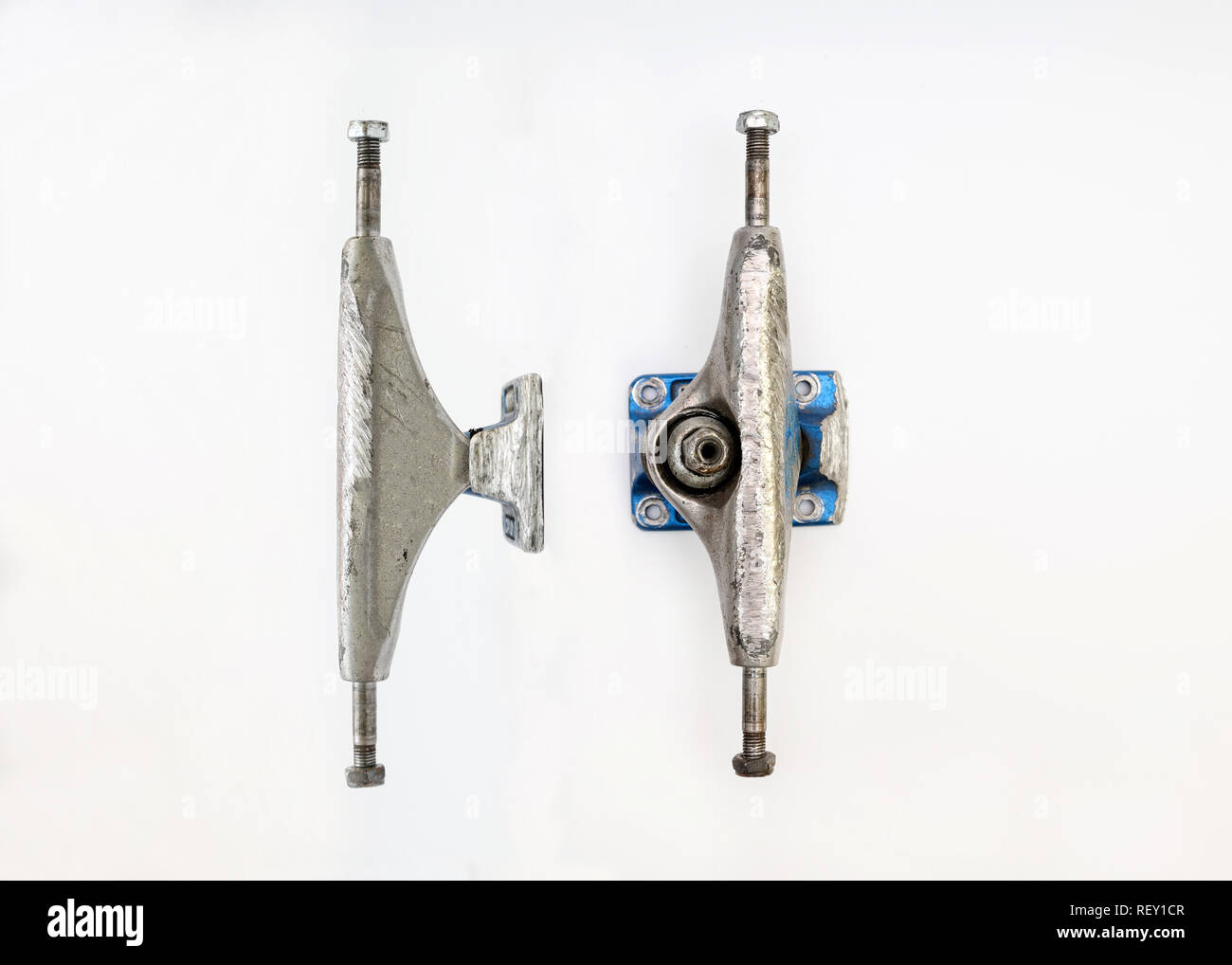 Used silver skateboard parts on a white background, two metal truck