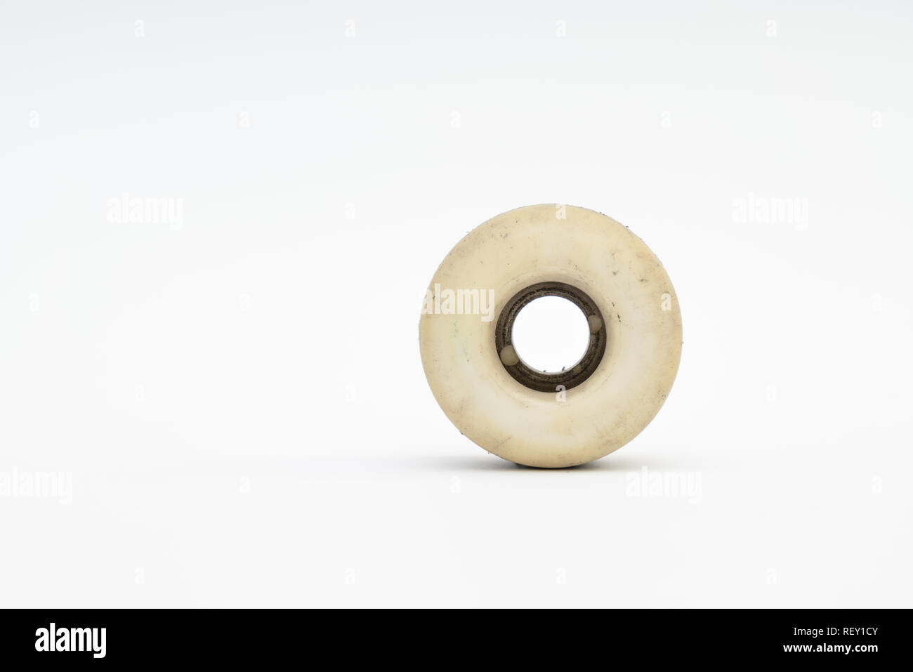 Close up of a skateboard wheel on white background. Complete skateboard
