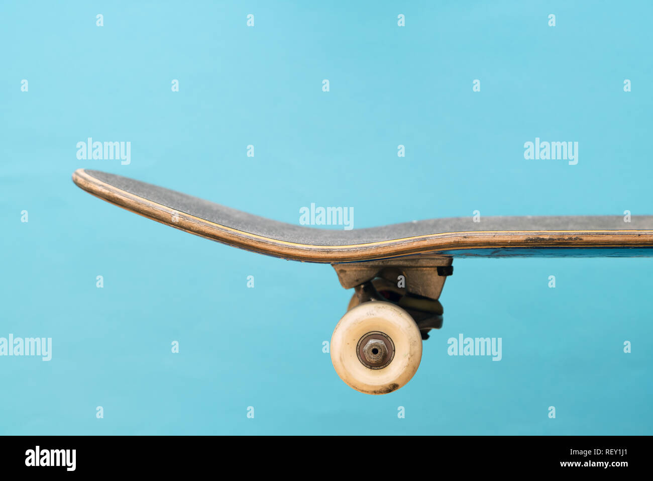 Professional skateboard on blue background side view, deck, complete