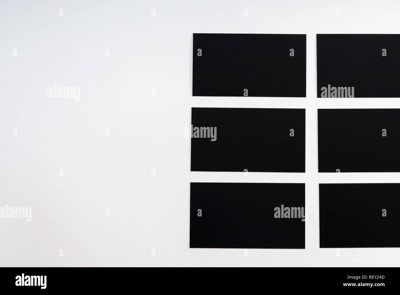 Photo of black blank business cards on a white background. Template for ID. Top view Stock Photo