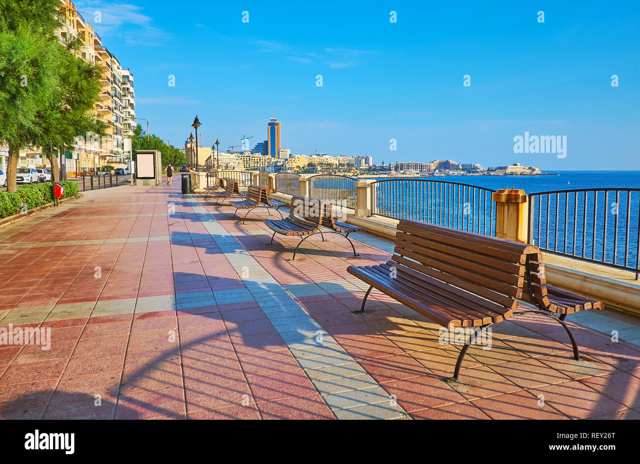 The modern seaside promenade of Sliema is the perfect place for morning jogging or lazy walks with nice views on the beach and St Julians coast, Malta Stock Photo