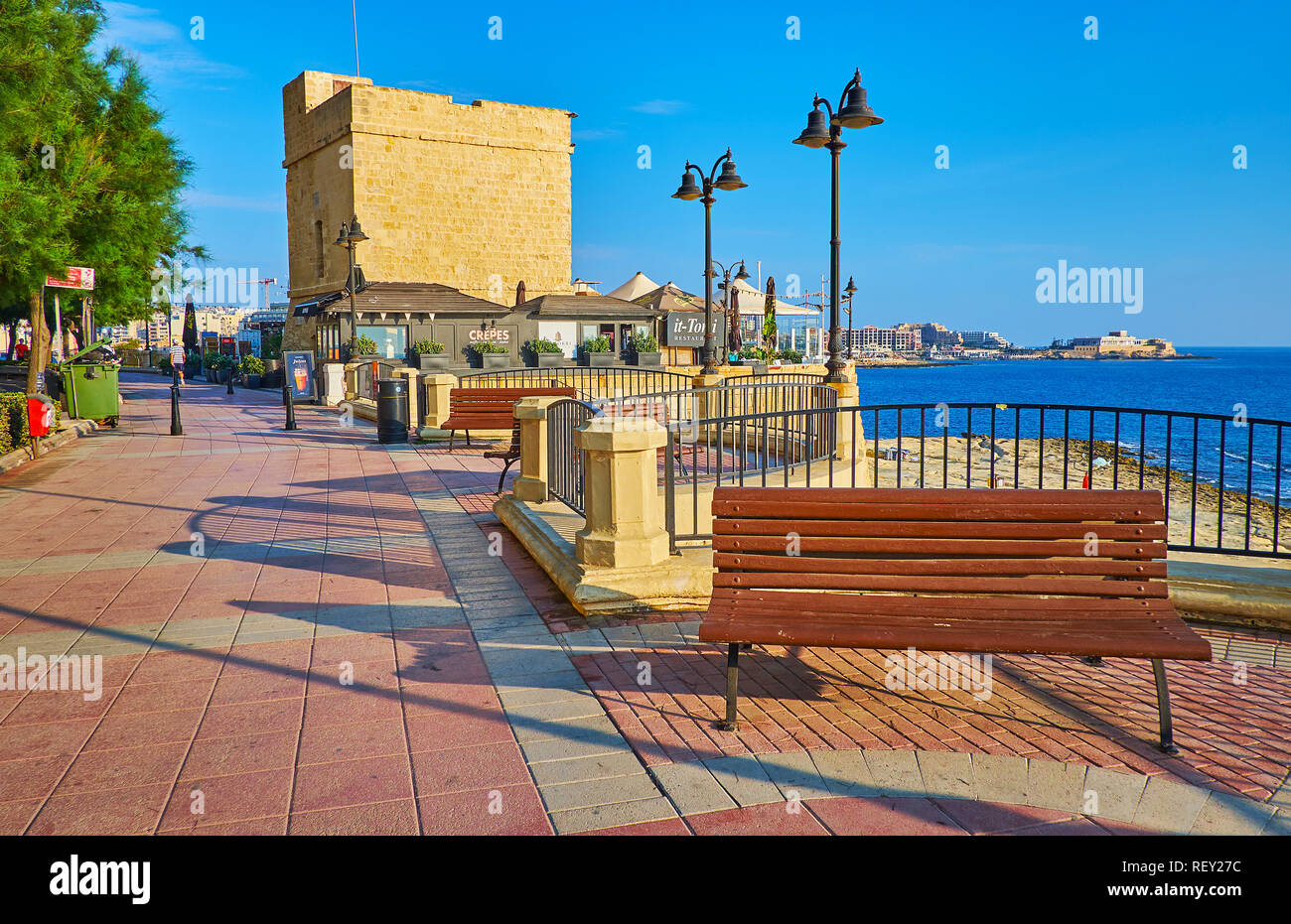 SLIEMA, MALTA - JUNE 20, 2018: The St Julian's Tower is located in seaside promenade and surrounded by cafes and recreational zone, on June 20 in Slie Stock Photo