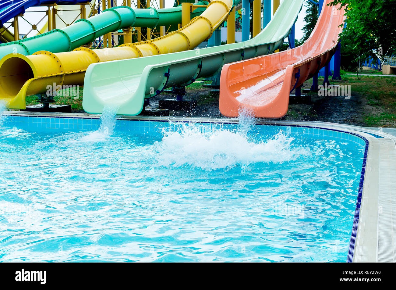 Colorful waterpark tubes and pool in aquapark. Water park slides close