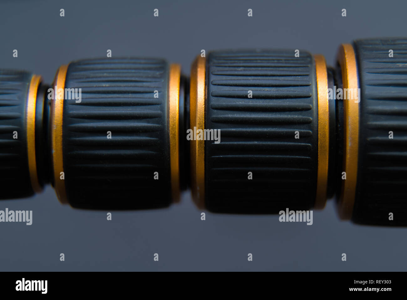 Black thread with golden edges on dark background and space for text Stock Photo