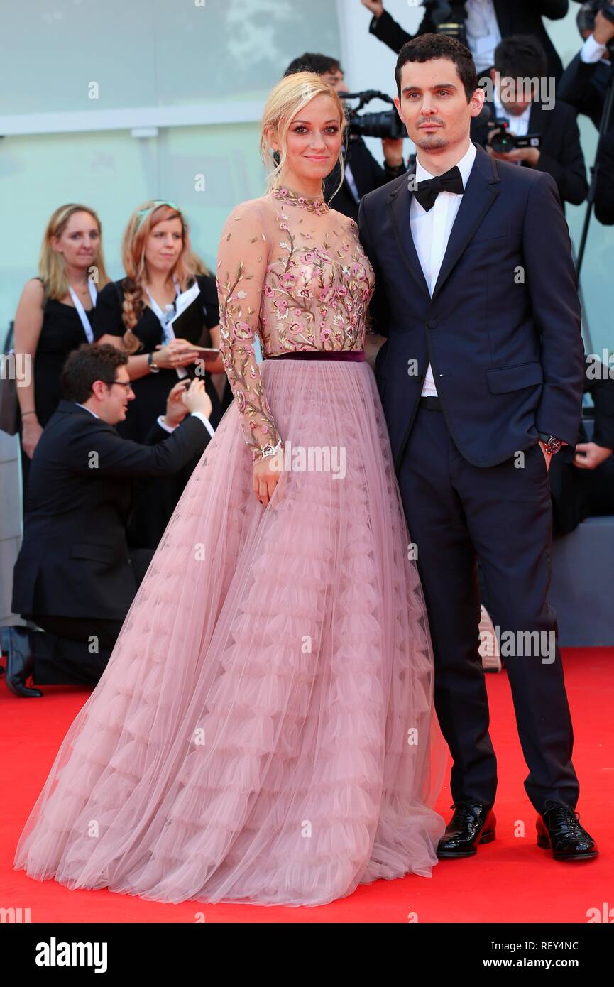 VENICE, ITALY – AUG 29, 2018: Damien Chazelle and Olivia Hamilton walk the red carpet ahead of the 'First Man' screening  (Ph: Mickael Chavet) Stock Photo