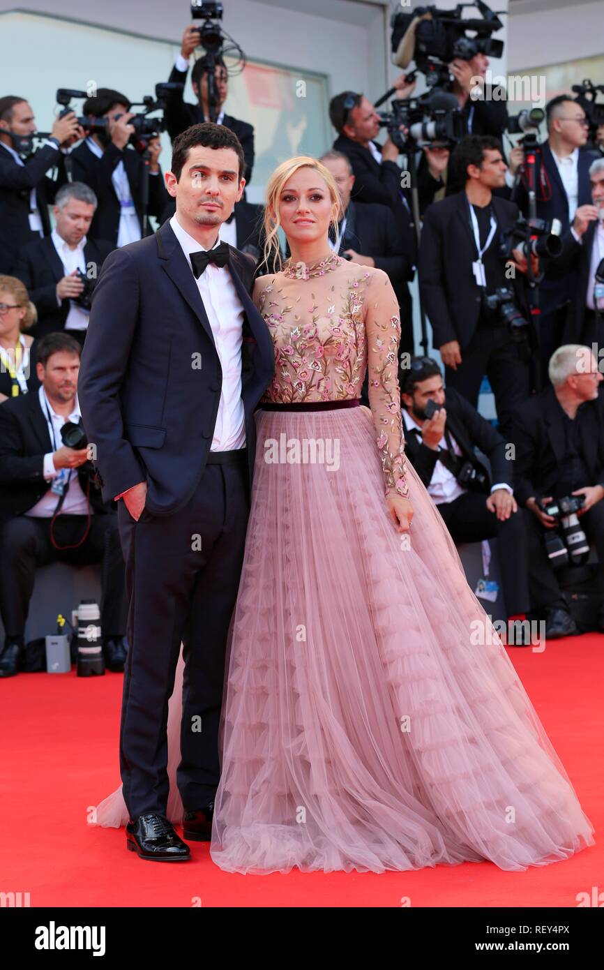 VENICE, ITALY – AUG 29, 2018: Damien Chazelle and Olivia Hamilton walk the red carpet ahead of the 'First Man' screening  (Ph: Mickael Chavet) Stock Photo