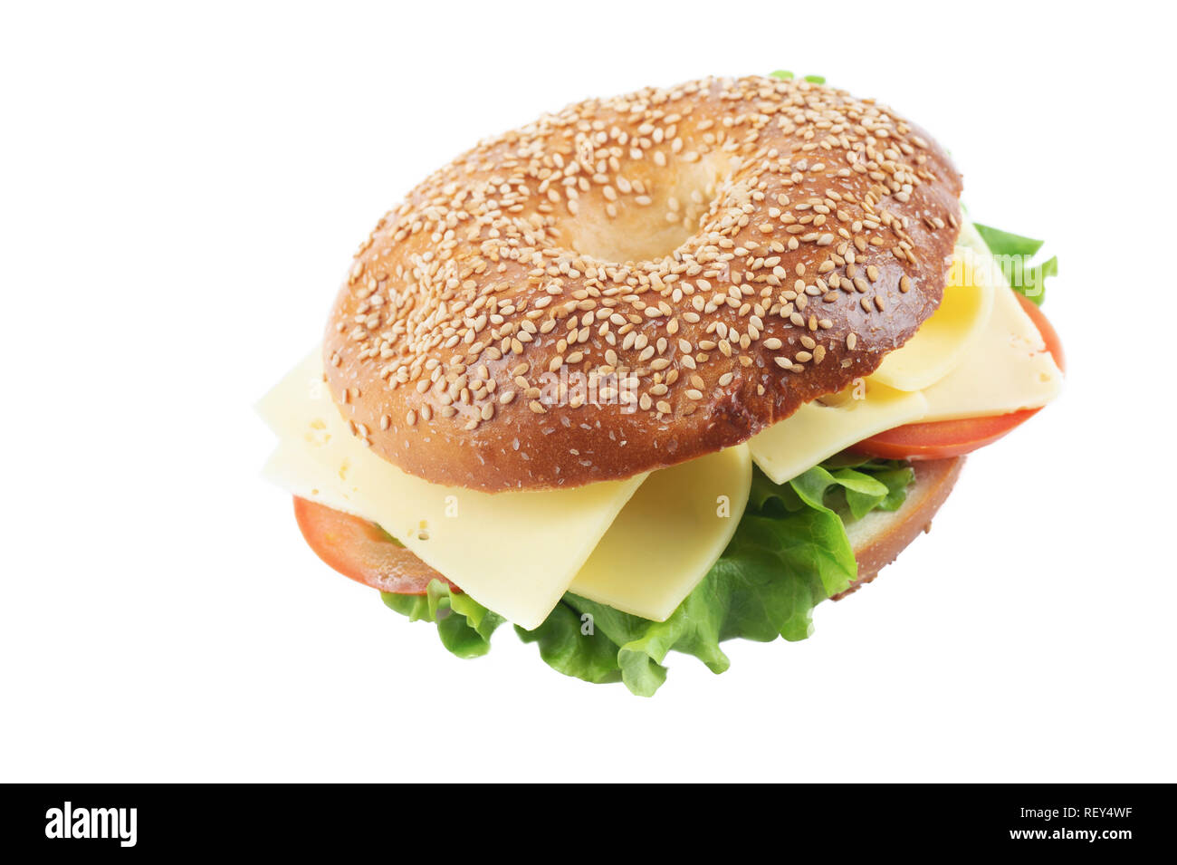 Fresh homemade bagel cheese, tomato and lettuce sandwich, isolated on white backgrond. Bagel with sesame seeds and sea salt. Stock Photo