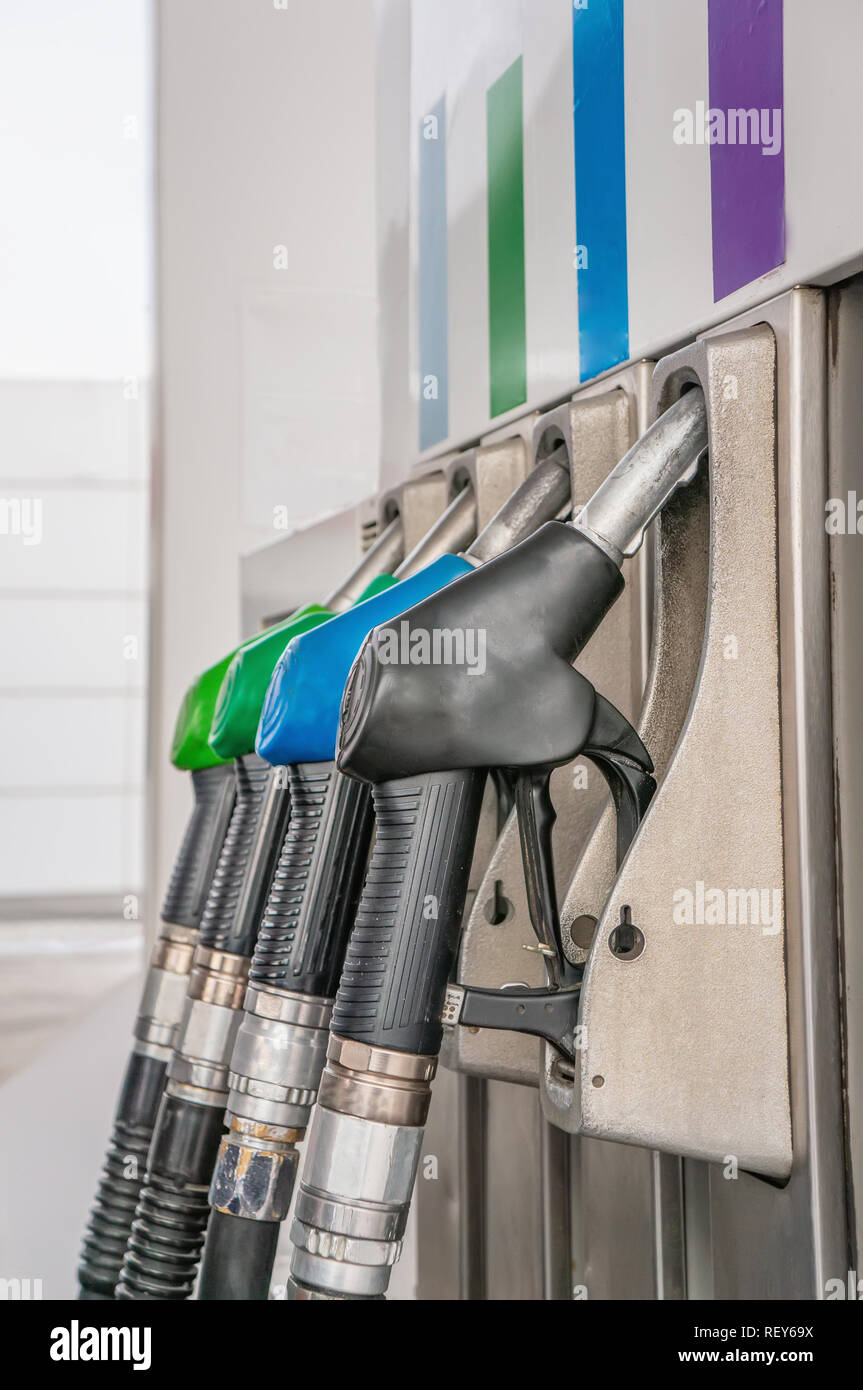 Closeup fuel pistols of petrol and diesel fuel on gas station Stock