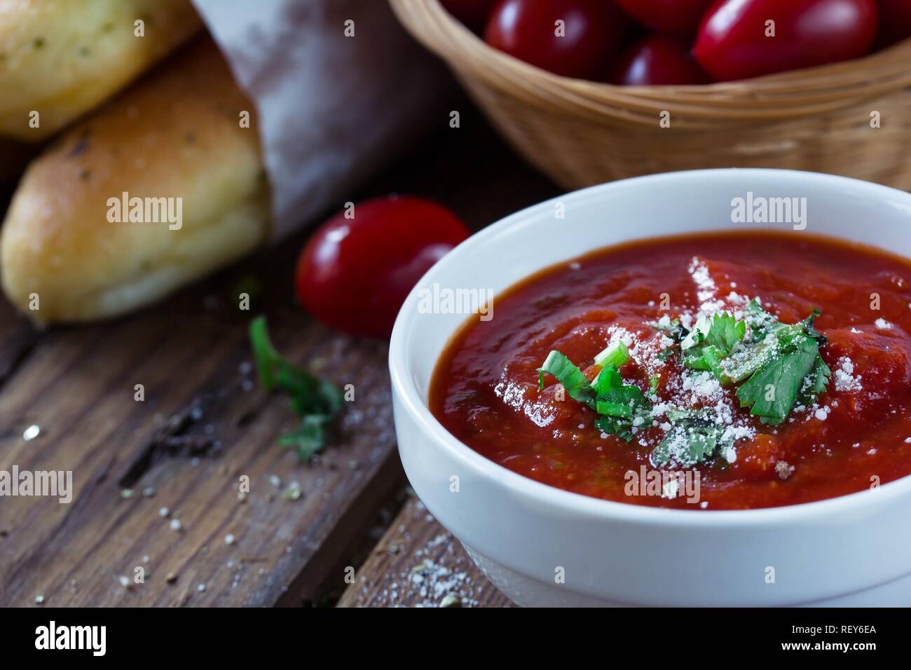 Fresh Marinara Pizza sauce in a bowl on wooden background, selective focus Stock Photo