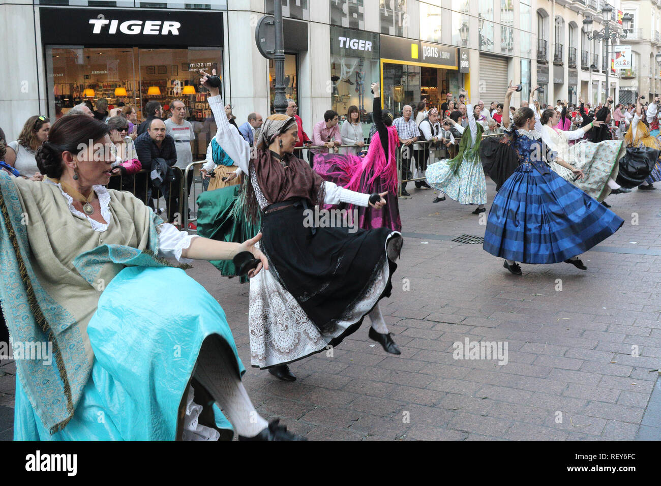 Group of dancing peasant country women in typical Spanish folkloristic dress during a reenactment parade (Ofrenda de flores) in Pilares 2017 festival Stock Photo