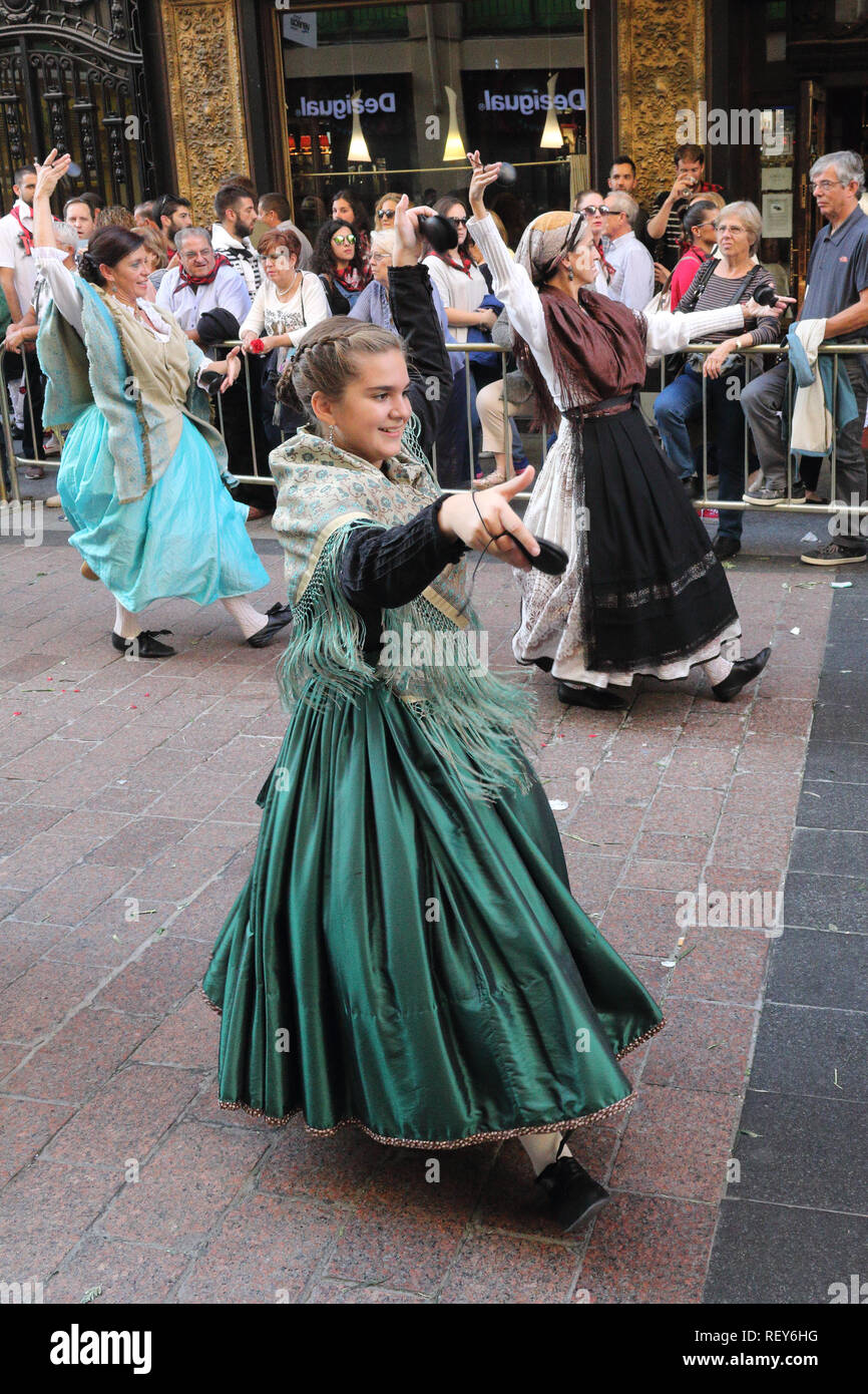 Group of dancing peasant country women in typical Spanish folkloristic dress during a reenactment parade (Ofrenda de flores) in Pilares 2017 festival Stock Photo