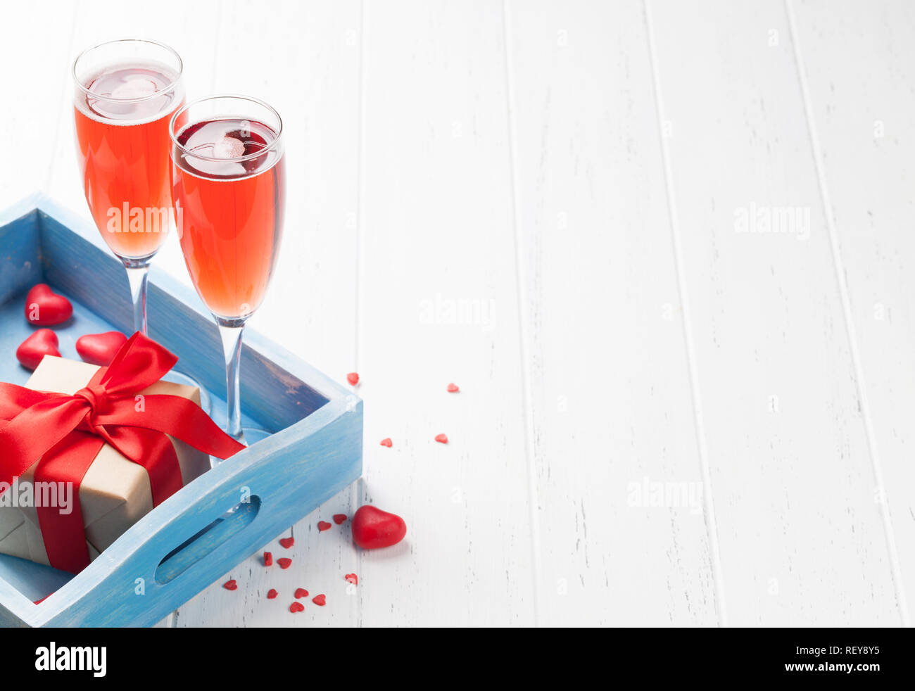 Valentine's day greeting card with rose champagne and gift box on ...