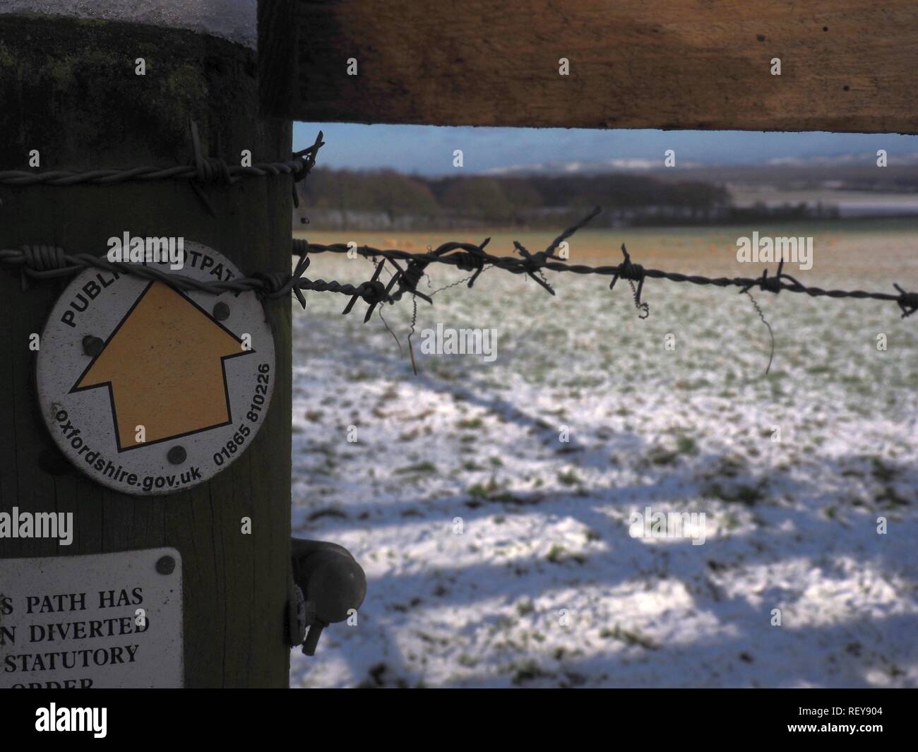 Public footpath sign in the snow in Forest Hill, Oxfordshire, UK Stock Photo