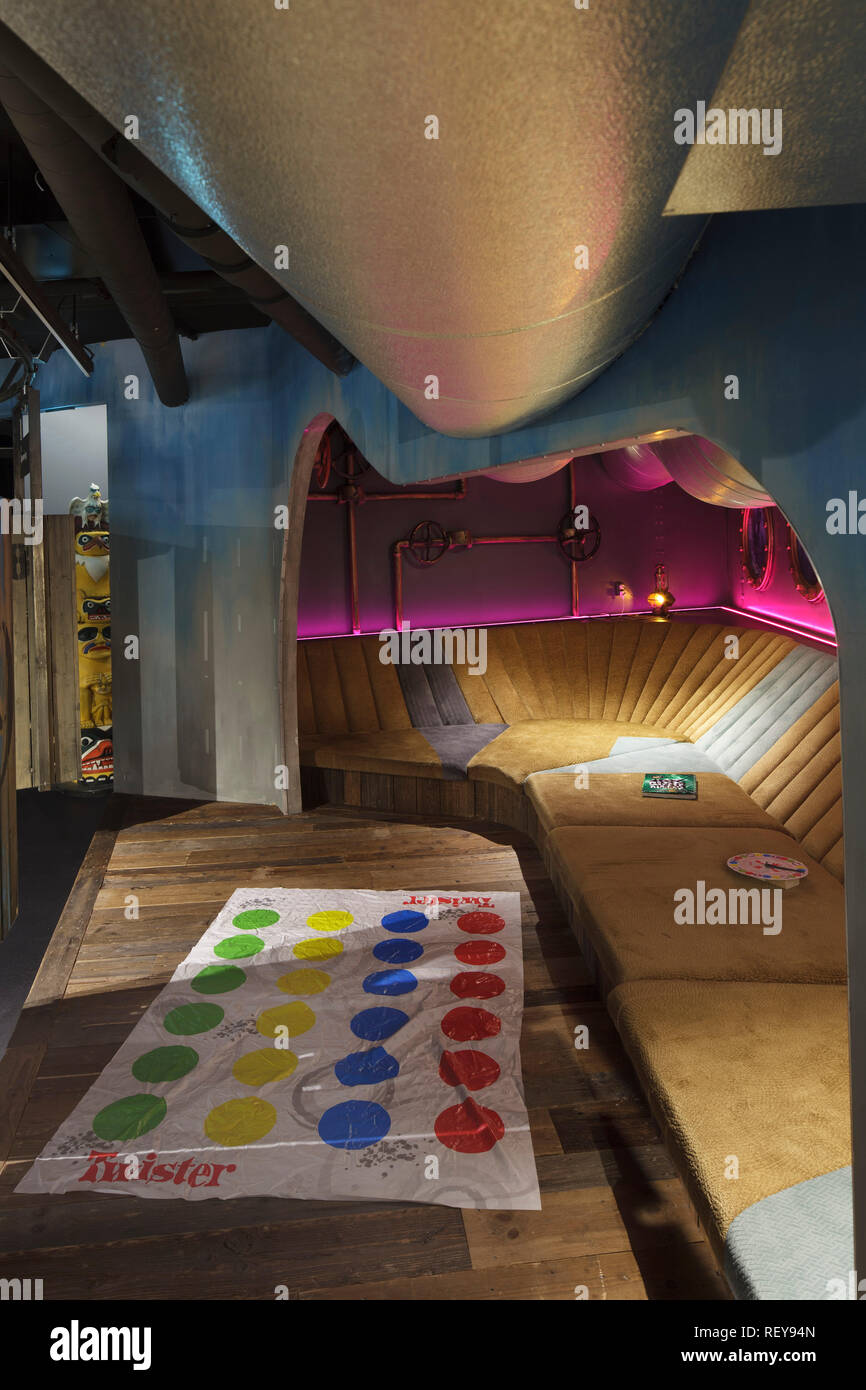 Submarine-themed seating area, with overhead portholes and pink lighting and Twister mat in foreground. Deichman Biblo Toyen Children's Library, Oslo, Stock Photo
