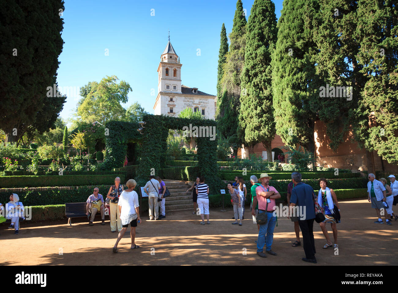 Tourists in the gardens in front of the Church of Saint Maria of Alhambra Stock Photo