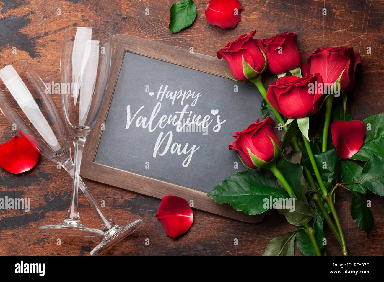 Valentine's day greeting card with champagne glasses and rose flowers ...