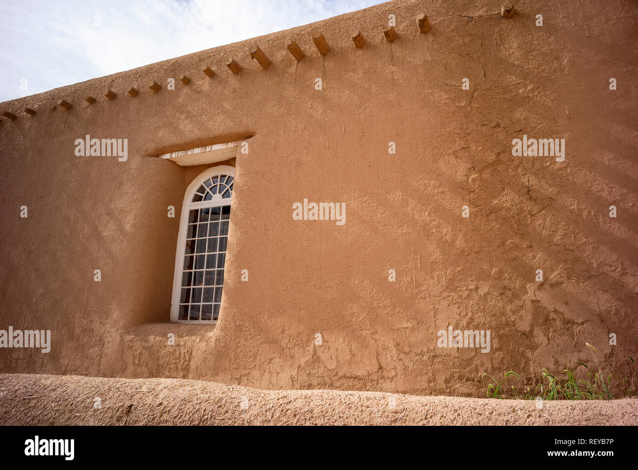 Shadows on a wall and window of San Francisco de Asis adobe church in Ranchos de Taos, New Mexico, USA Stock Photo