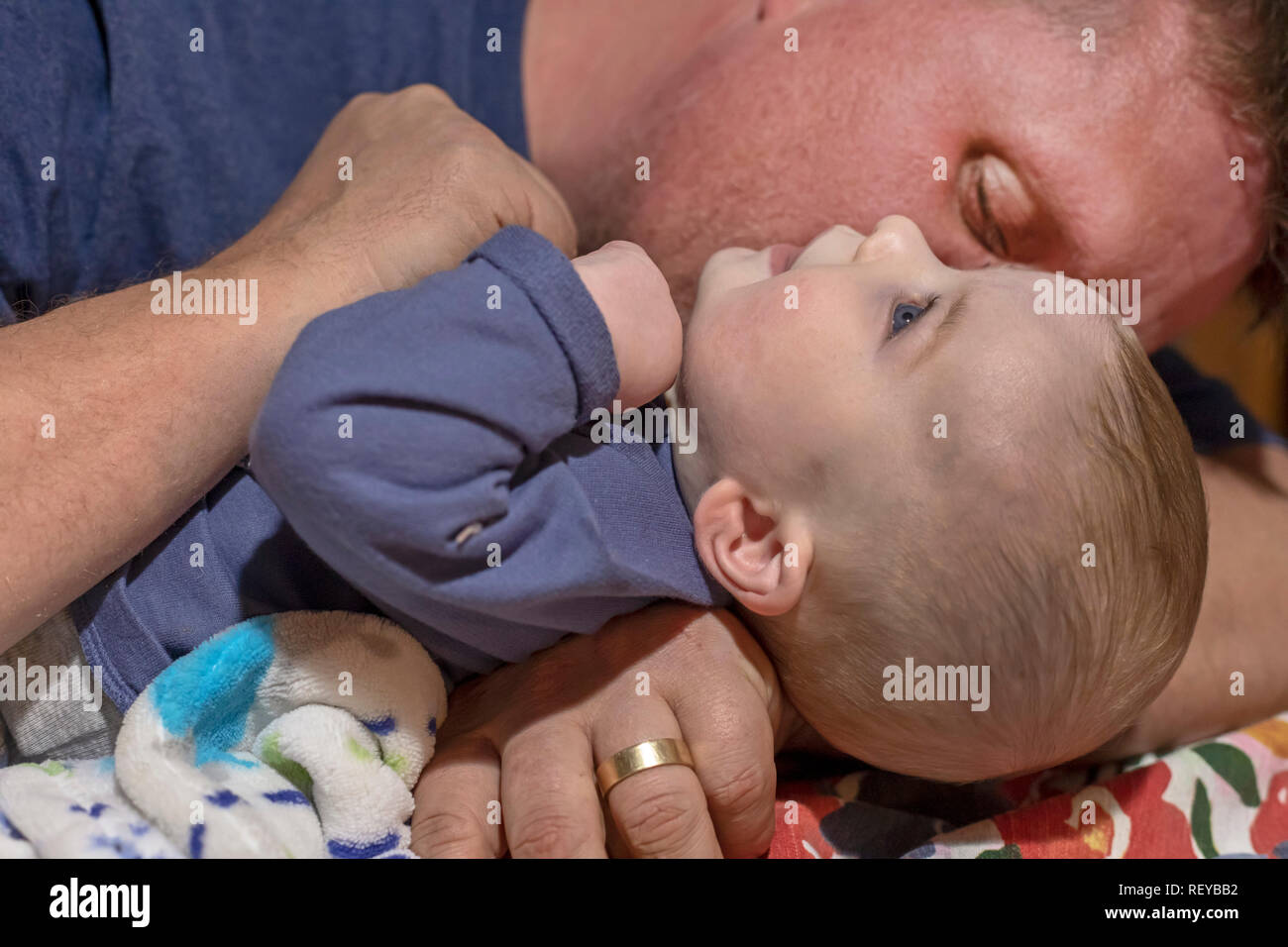 Denver, Colorado - Adam Hjermstad Sr. kisses his four-month-old son, Hendrix. Stock Photo