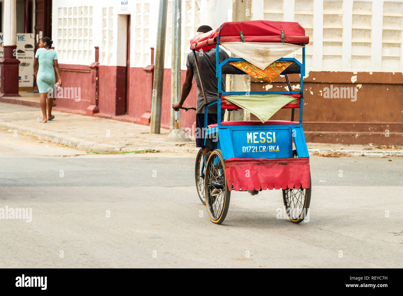 Toliara, Madagascar - Jan 10th, 2019: A man moving a cycle pousse pousse coupled with the name of Messi intended on the nameplate in birth back in Toliara, M Pool Photo