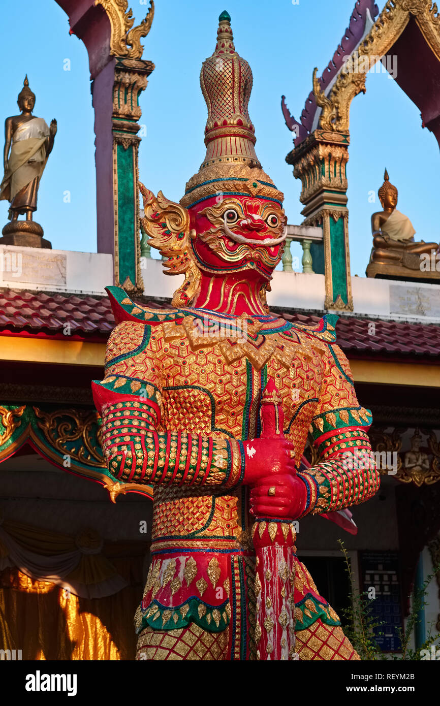 A Yak or demon figure guarding the Reclining Buddha of Wat Sri Sunthorn (Soonthorn) in Thalang, Phuket, Thailand, bathed in early morning light Stock Photo