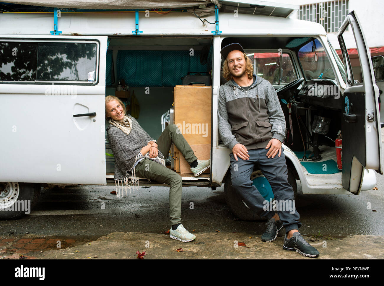 Volkswagen Camper van with a happy European travelling couple. Travel lifestyle (environmental portrait, editorial use). Medellín, Colombia. Sep 2018 Stock Photo