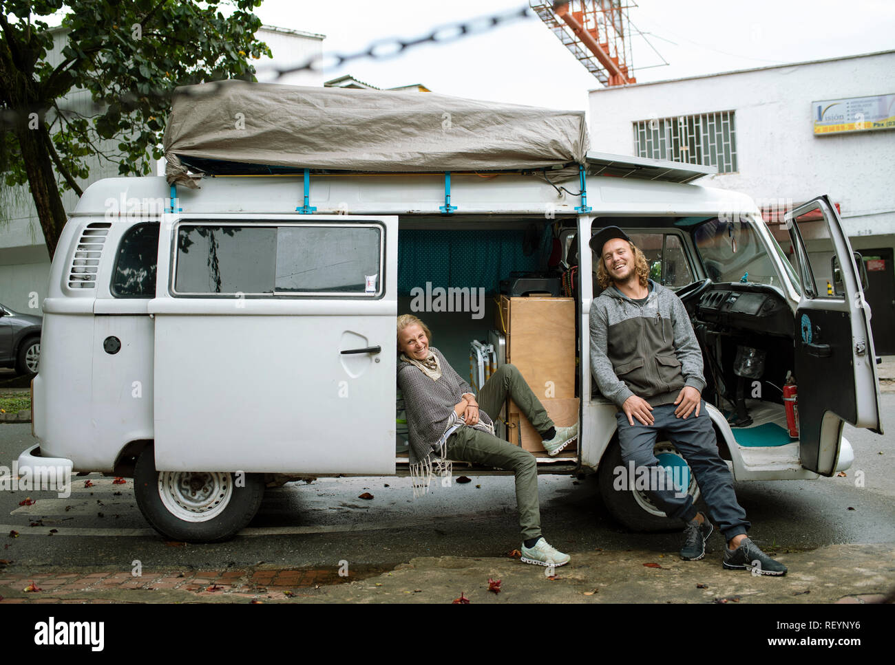 Volkswagen Camper van with a young European travelling couple. Travel lifestyle (environmental portrait, editorial use). Medellín, Colombia. Sep 2018 Stock Photo