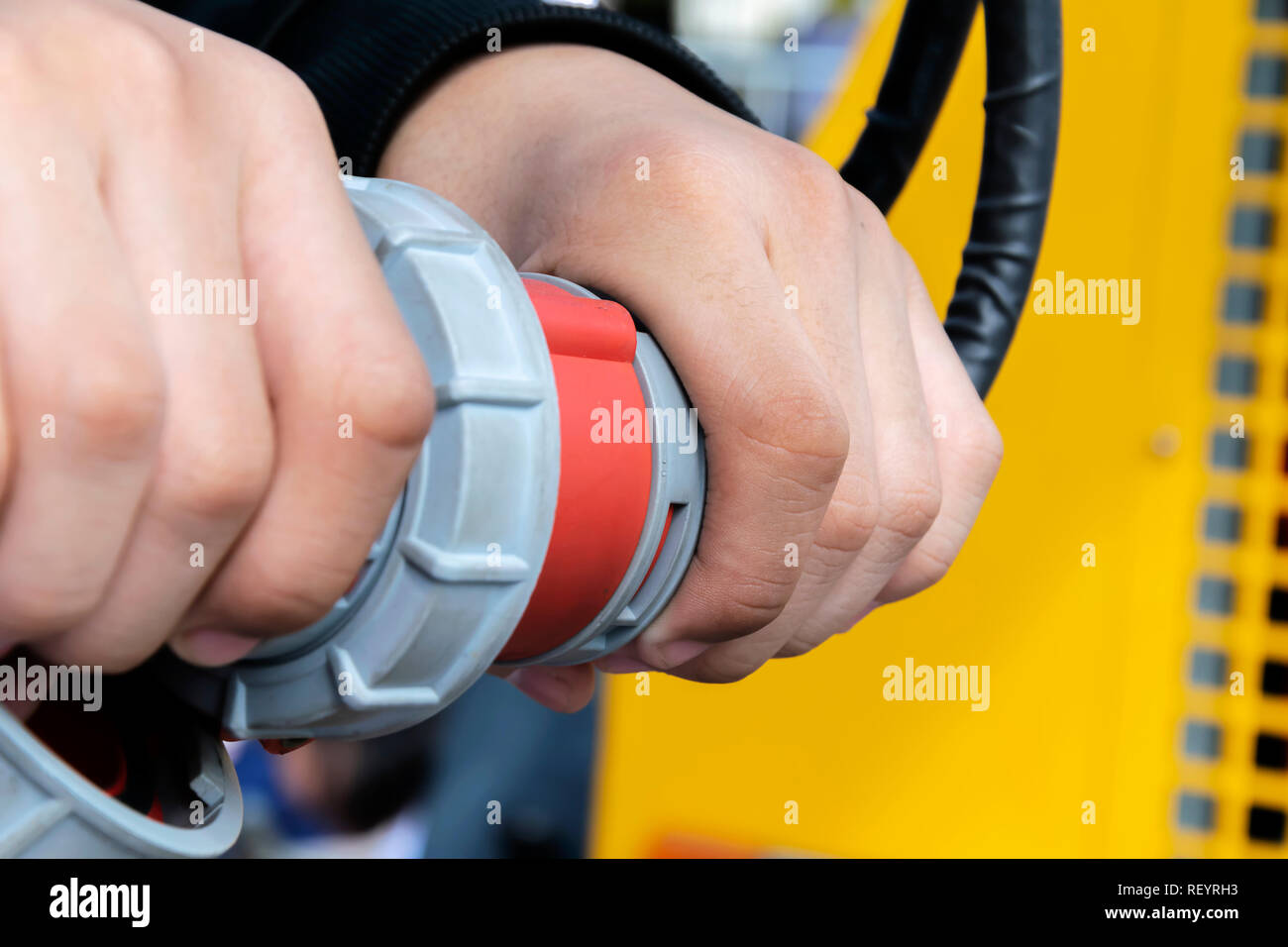 Engineers are connecting wires to start work. Industrial work is a security requirement. And it requires a lot of electricity to run the machine. Stock Photo