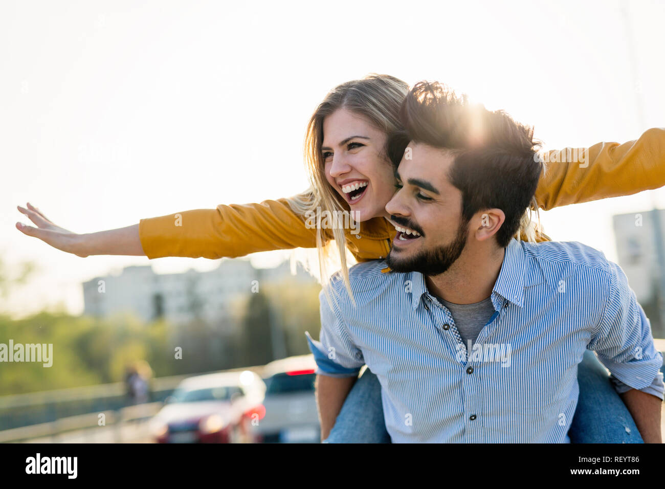 Couple in love having fun carrying piggyback - freedom concept Stock Photo