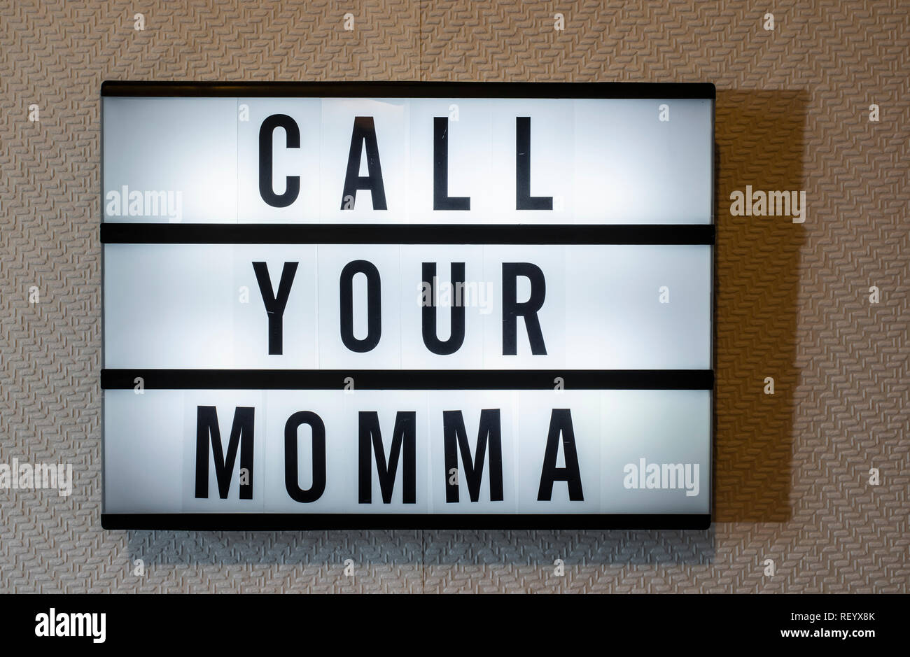 Message Call Your Momma On Illuminated Board Mothers Day Concept With Text Daylight From Window Room Interior Black Letters Momma On White Wallpap Stock Photo Alamy