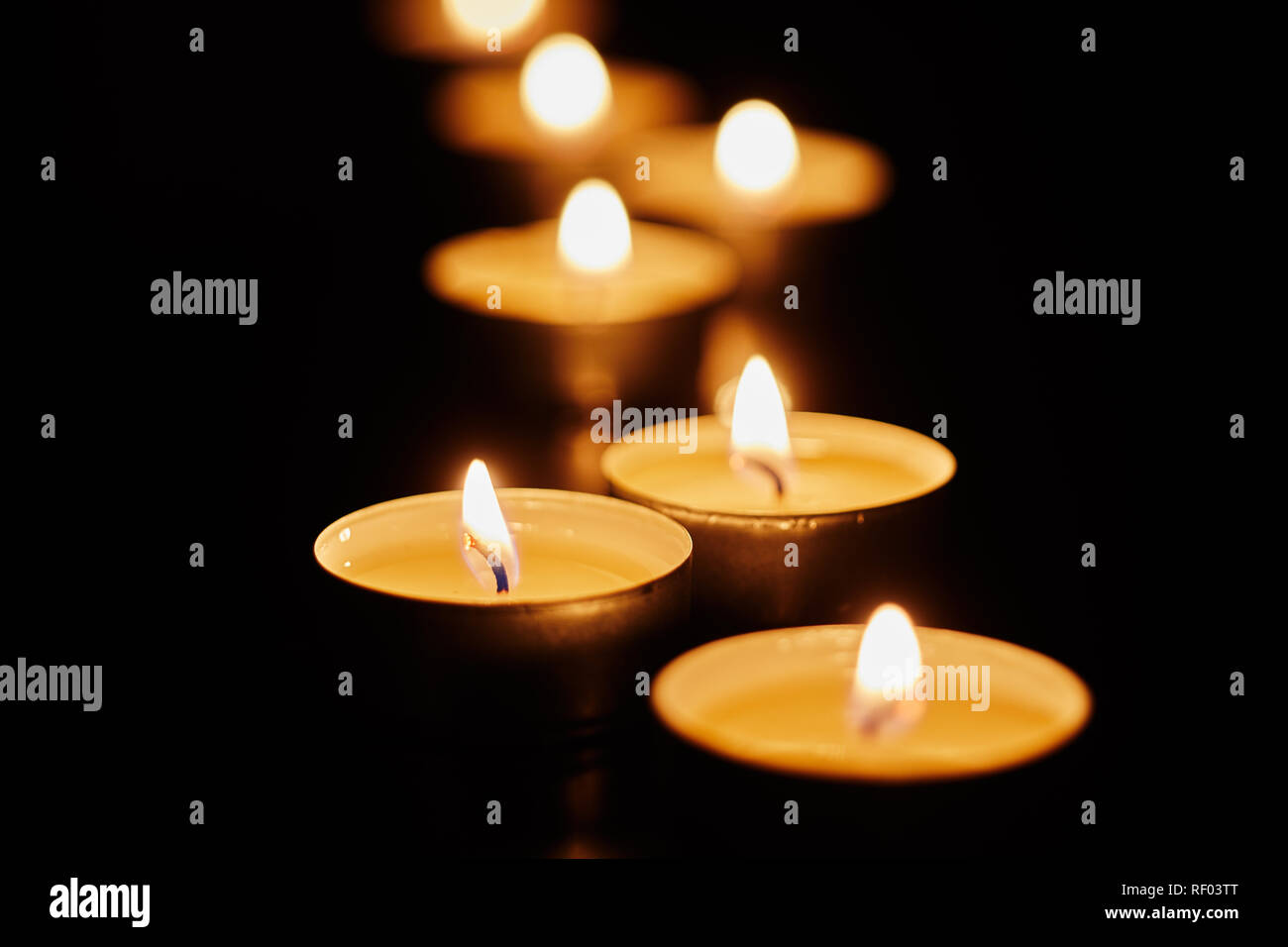 Inspirational religious still life with burning votive candles for