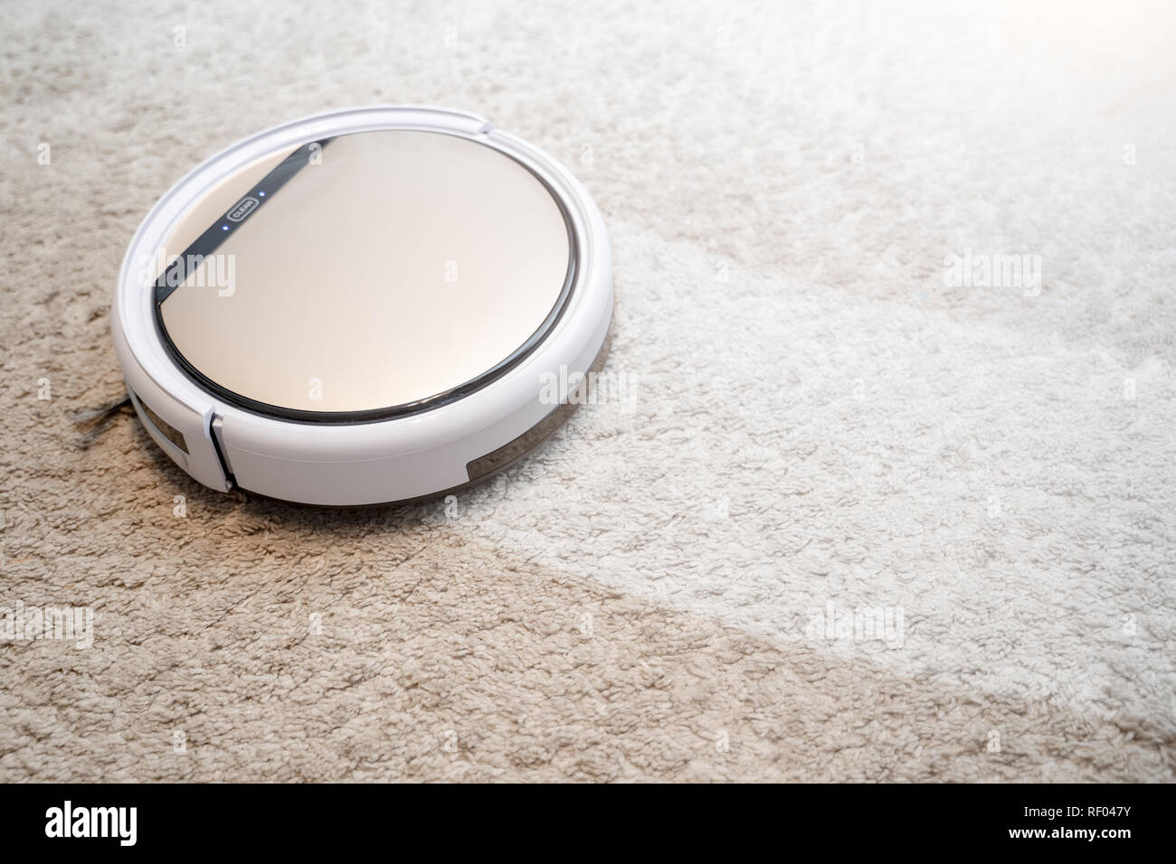 Robotic vacuum cleaner working on carpet. Smart cleaning technology