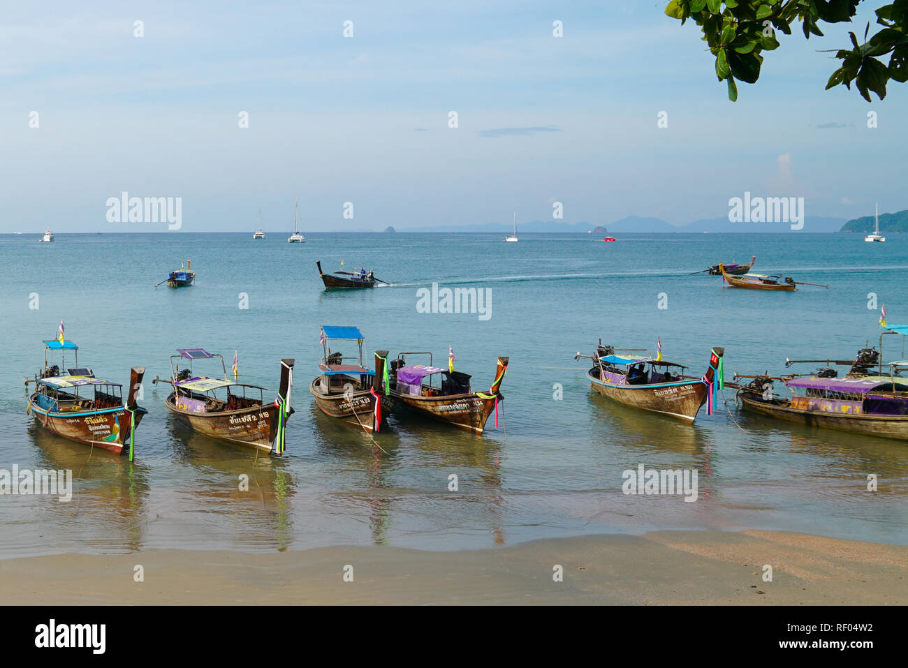 Aonang Beach, Krabi, Thailand, 1st January 2019: Morning scene with long tail boats at lovely Aonang beach. Stock Photo