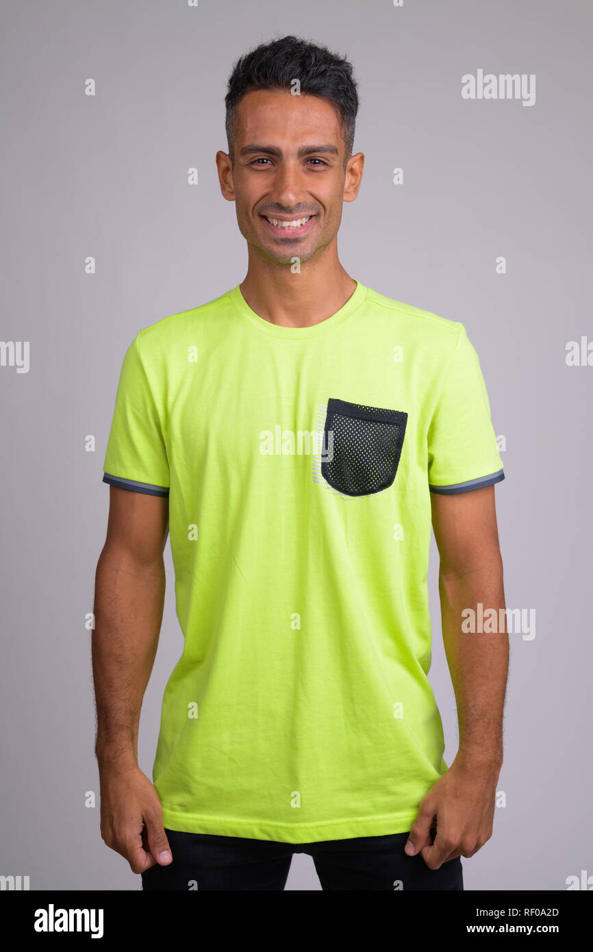 Portrait of young happy Persian man smiling ready for gym Stock Photo ...