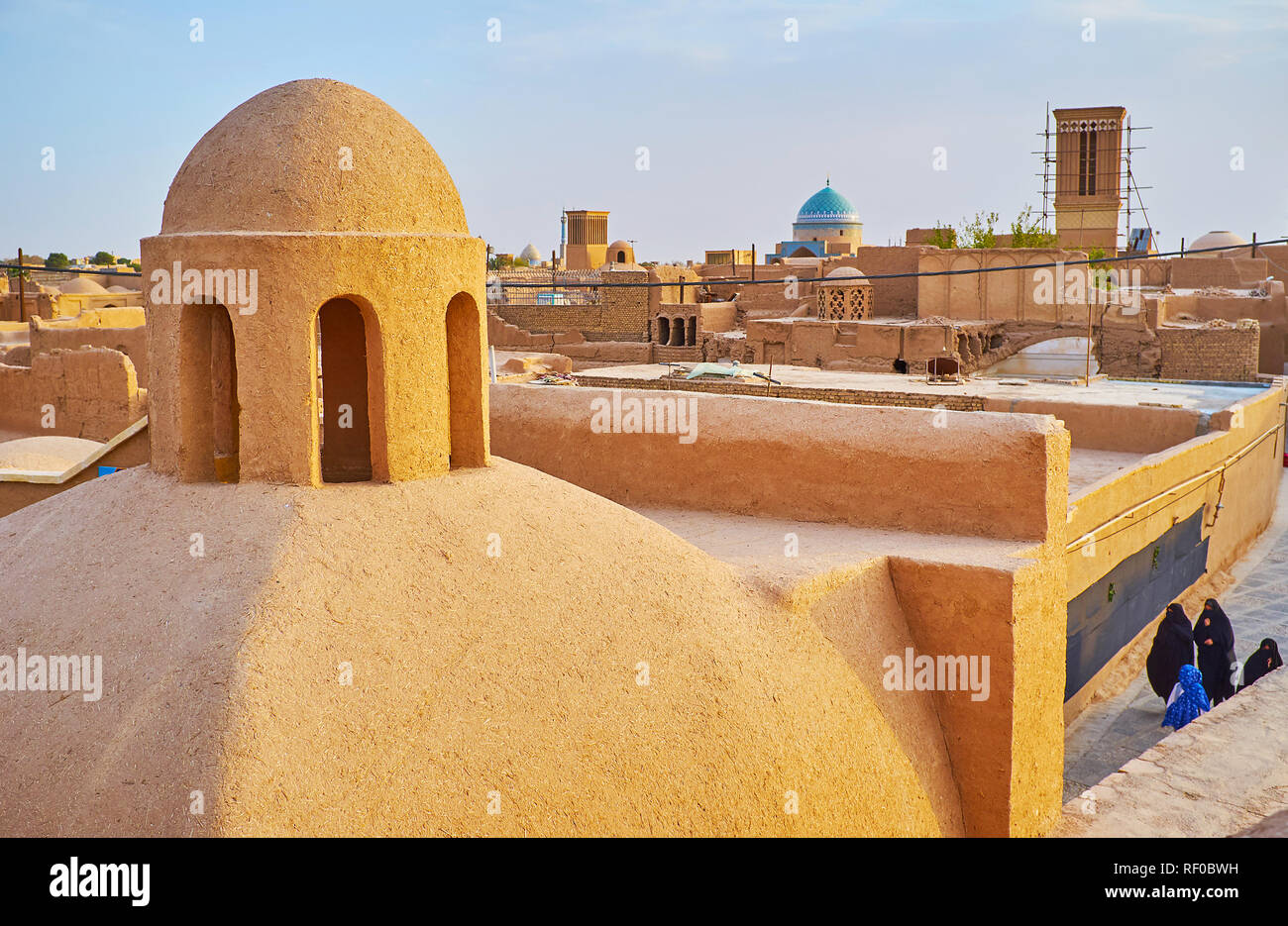 The medieval cityscape of Yazd with preserved mudbrick quarters of Fahadan district and adobe dome with chimney on the foreground, Iran. Stock Photo